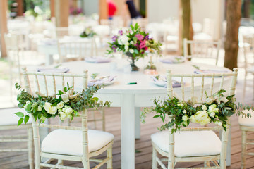 chairs with flowers and eucalyptus
