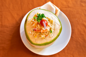 Fried rice with shrimps and egg, tomato and greens. In the young coconut  instead of plate