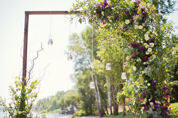 wedding arch with hanging burning candles