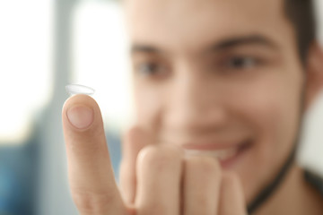 Man holding contact lens, closeup