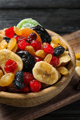 Bowl with different dried fruits on wooden background. Healthy lifestyle