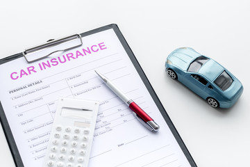 Car insurance concept with form, car toy and calculator on white background