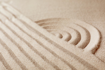 Fototapeta na wymiar Zen garden pattern on sand. Meditation and harmony