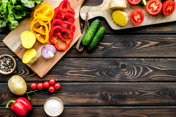 Fototapeta na wymiar Fresh food ingredients for vegetarian kitchen on wooden background top view mock-up