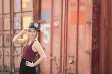 beautiful young female posing in front of metal wall