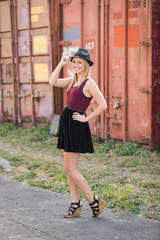 Beautiful young woman posing in front of boxcar