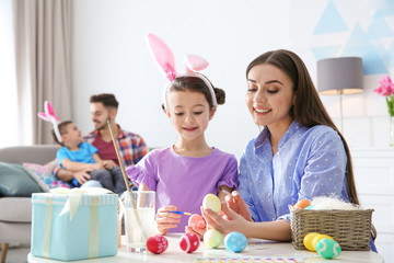 Happy family preparing for Easter holiday at home