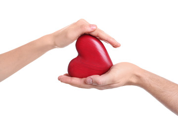 Man and woman holding decorative heart on white background, closeup