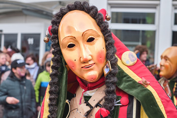 Colorful carnival figure with friendly mask. Street Carnival in Southern Germany - Black Forest.