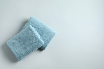 Fresh fluffy folded towels on grey background, top view. Space for text