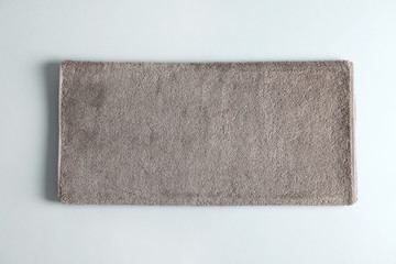Fresh fluffy towel on grey background, top view. Mockup for design