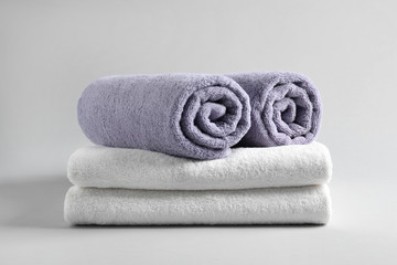 Obraz na płótnie Canvas Stack of fresh fluffy towels on grey background