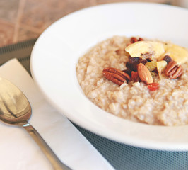 Close up bowl of breakfast oatmeal with dried fruit