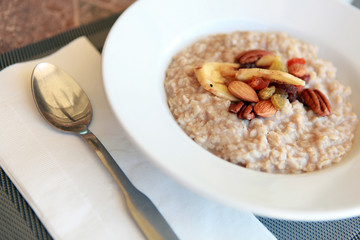 close up bowl of breakfast oatmeal with dried fruit