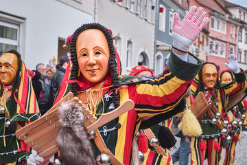 Colorful carnival figure waving in the camera. Street Carnival in Southern Germany - Black Forest.
