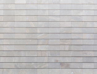 Full frame background of a new, modern and clean stone wall or building exterior.