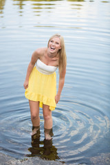 Beautiful young woman laughing in water