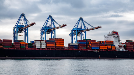container ship being loaded at the Port of Genoa, Italy © Master Of Footage