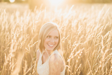 Beautiful young girl laughing in wheat field
