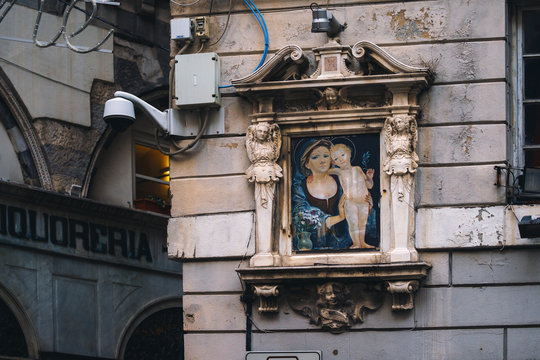 Madonna shrine on the facade of the old house in Genoa, Italy