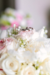 Wedding bouquet with rings on top from side view