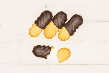 Group of three whole two halves of lazy cookie with chocolate flatlay on white wood