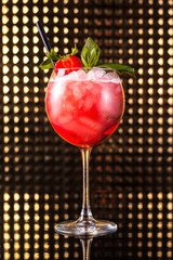 Red fruit cocktail in tall round glass