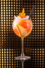 Orange fruit cocktail with grapefruit in tall round glass