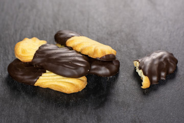 Group of four whole one piece of lazy cookie with chocolate on grey stone