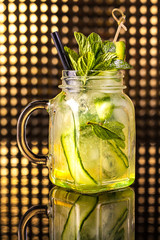 Green fruit cocktail lemonade with fresh cucumber in vintage jar
