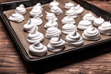 Meringues on backing paper close up