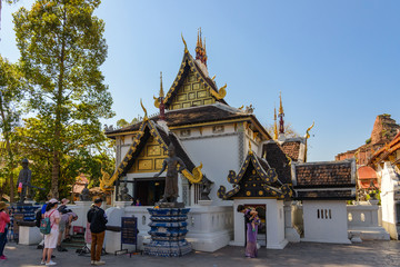 Fototapeta na wymiar Outdoor sunny view of small beautiful Thai temple in Wat Chedi Luang, famous and renown historical religious architecture in Northern Thailand.