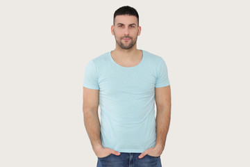 Studio portrait of a handsome bearded man in a blue t-shirt