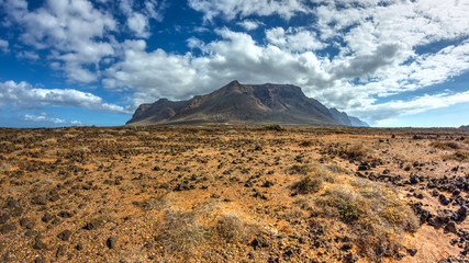 Desert landscape with a mountain massif in the background in the island of Tenerife