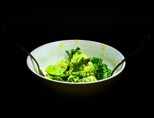 Salad in the white bowl.