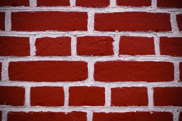 wall of red bricks with white paint texture, background. vignette, exterior