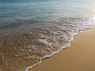 Small waves in an empty beach shore.