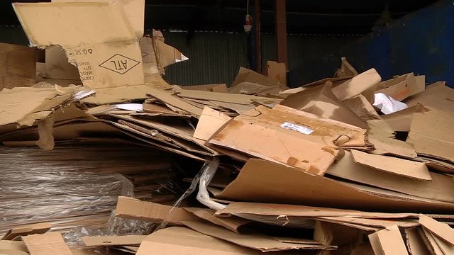 A pile of cardboard packaging ready for pressing
