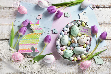 pastel color easter flat lay with tulips eggs and bunnies