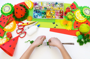 Paper cap diy for fruit party. Watermelon Birthday. Children's hands make crafts.