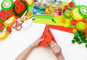 Paper cap diy for fruit party. Watermelon Birthday. Children's hands make crafts.
