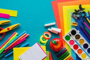 Stationery for study at school lies on blue. Back to school. Rainbow color