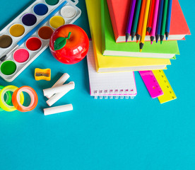 Stationery for study at school lies on blue. Back to school. Rainbow color