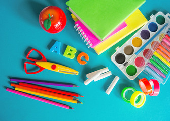 Stationery for study at school lies on blue. Back to school. Rainbow color