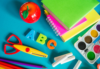 Stationery for study at school lies on blue. Back to school. Rainbow color