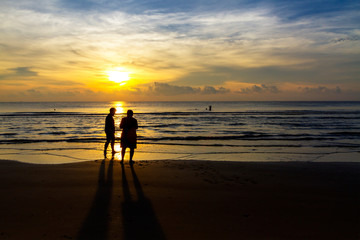The tourist and sunrise on beach