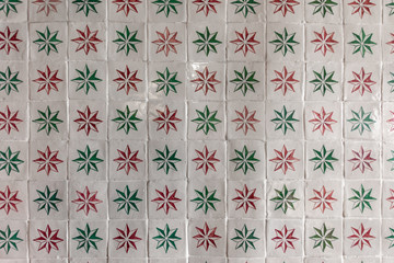 Ornate brightly colored portugese tile texture in white, green and red - 255275504