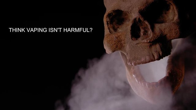 THINK VAPING ISN'T HARMFUL?  HUMAN SKULL VAPES AS A MESSAGE APPEARS IN NEGATIVE SPACE.  SHOT IN 4K, 10 BIT, ALL-INTRA.
