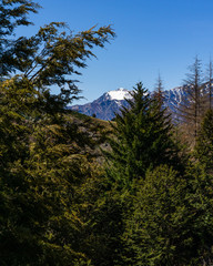 peaceful landscape during sunny day with calm sky above mountain range, perfect hiking area