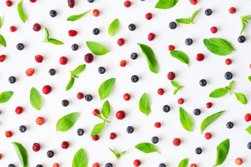 Wild strawberry, blueberry and mint leaves isolated over white background, top view